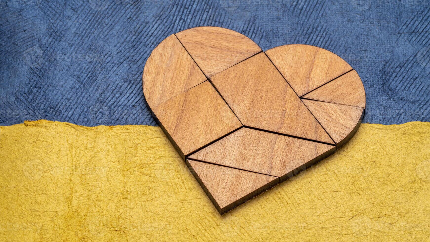 heart tangram against paper abstract in blue and yellow photo