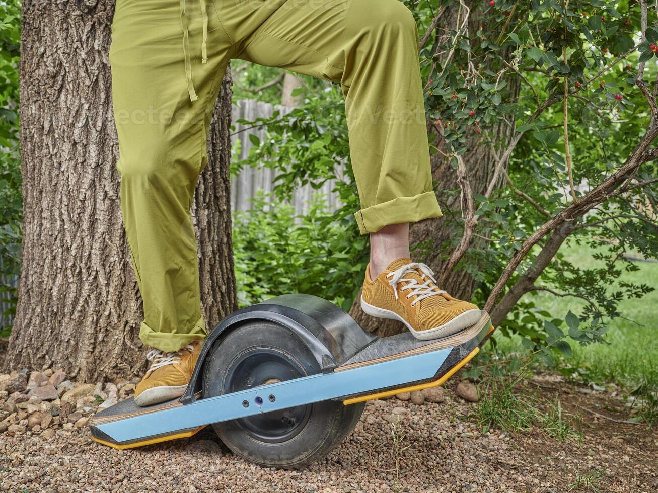 one-wheeled electric skateboard in a backyard photo
