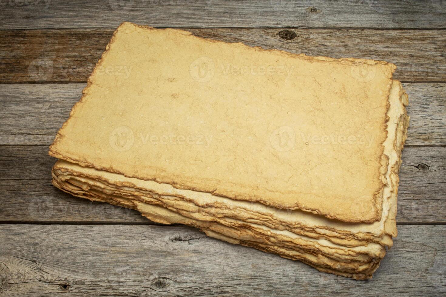stack of blank handmade paper with rough edges photo