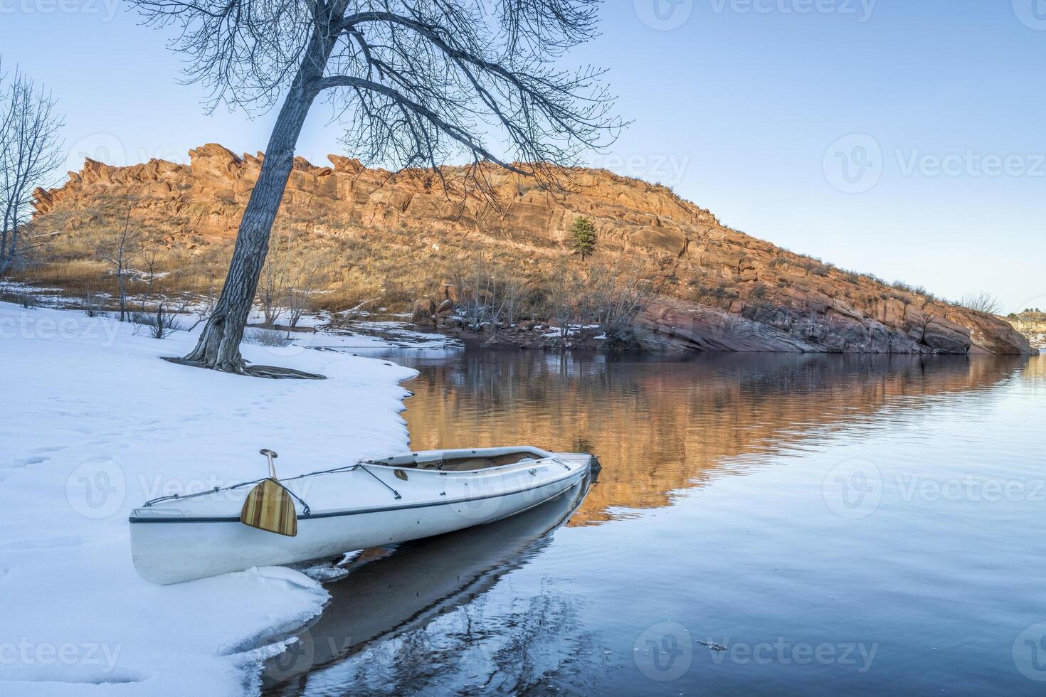 decked expedition canoe in winter scenery photo