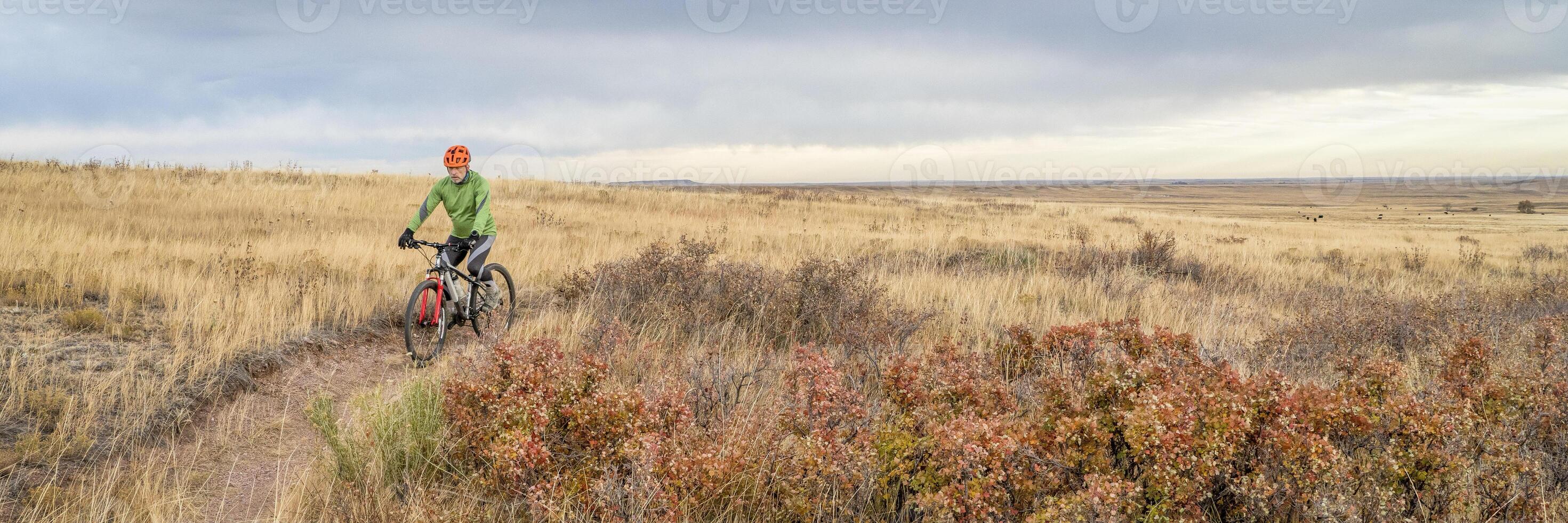 senior cyclist on mountain bike in Colorado prairie photo