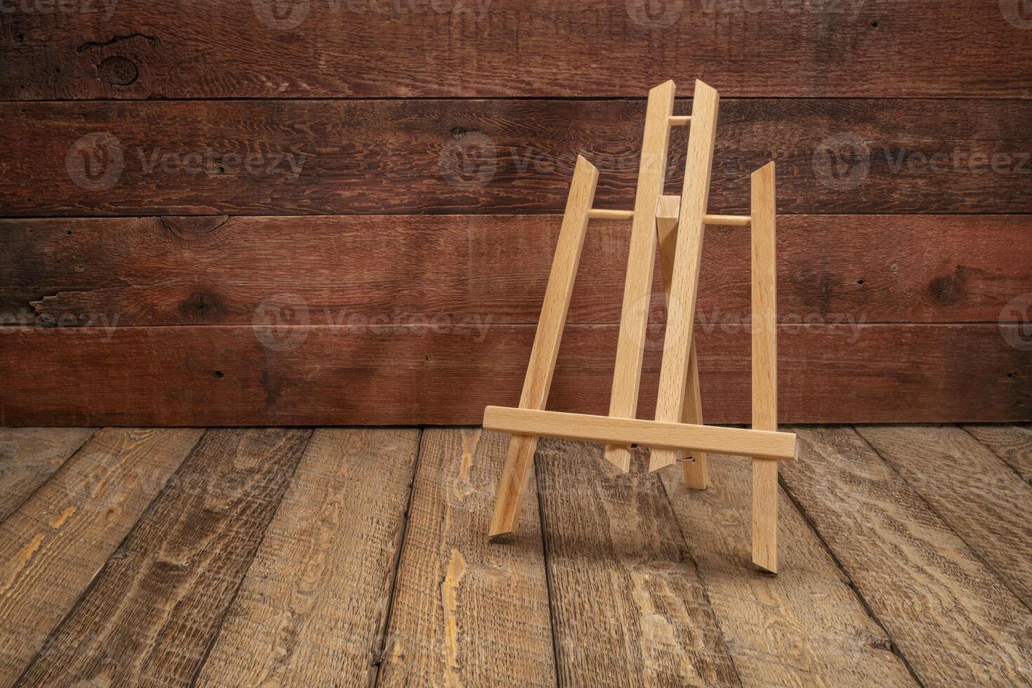 small empty easel against rustic wood photo