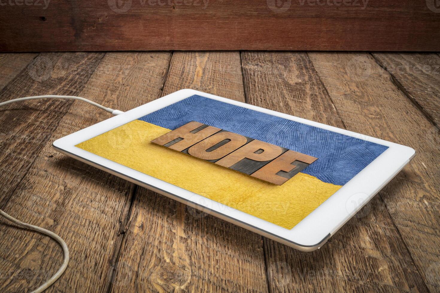 hope word in vintage wood type against Ukraine colors photo