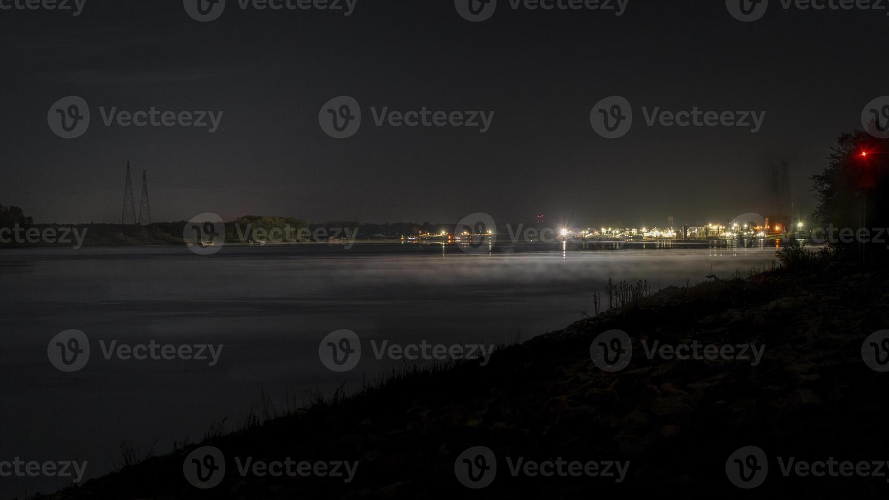 night on the Mississippi River with lights of shipyard facilities above confluence with the Missouri River photo