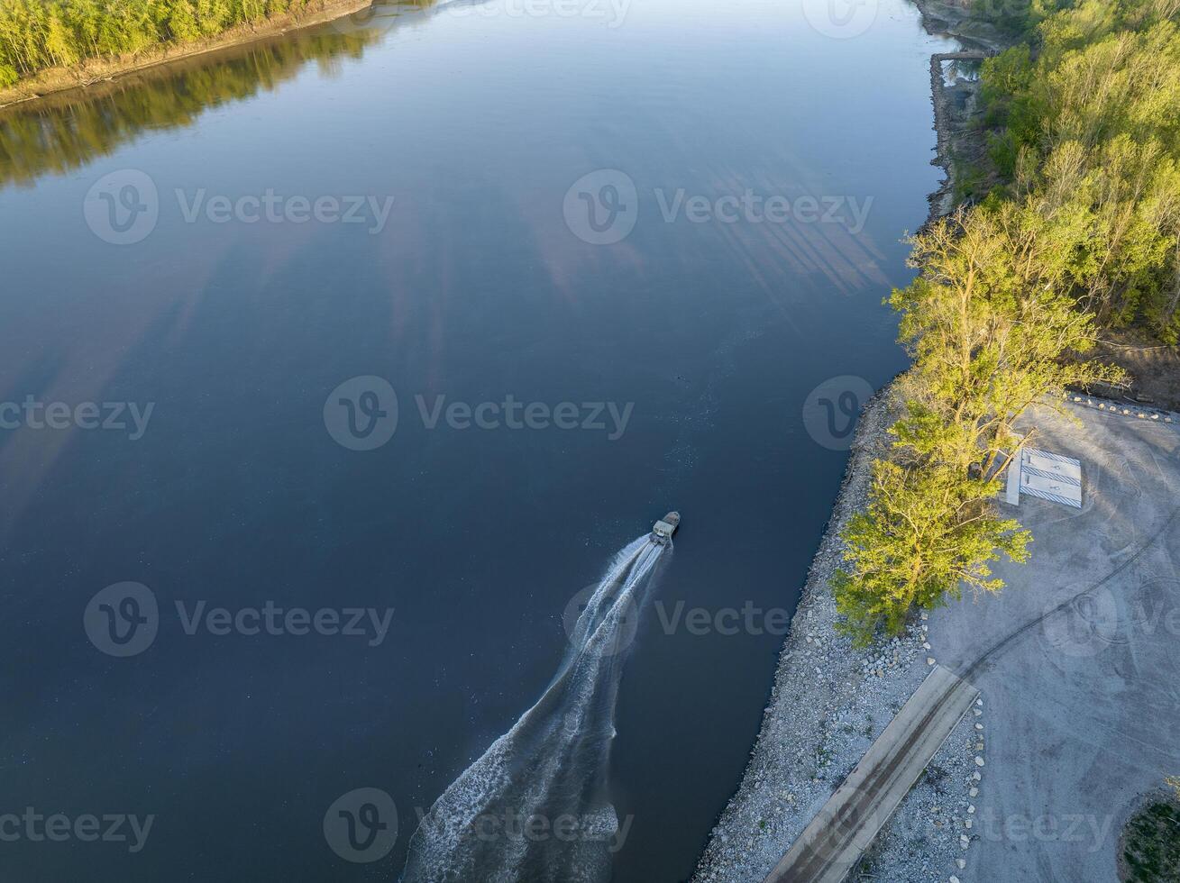 fishing boat leaving a ramp - sunrise aerial view of Missouri River at Dalton Bottom photo