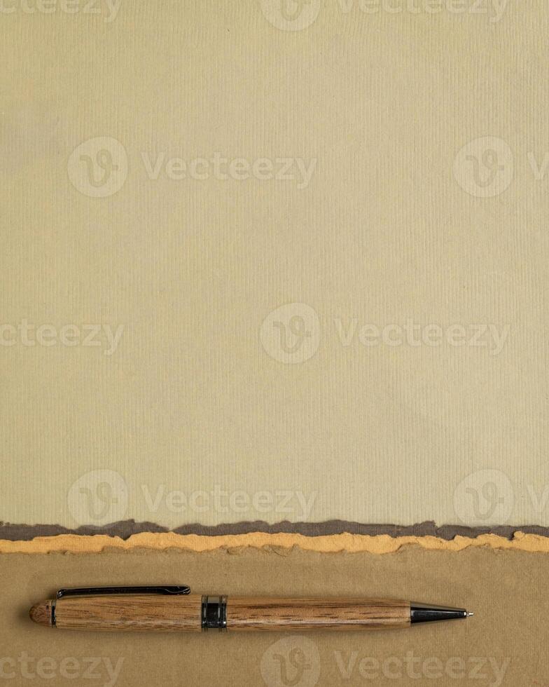 abstract paper landscape in pastel earth tones tones - collection of handmade rag papers with a pen photo