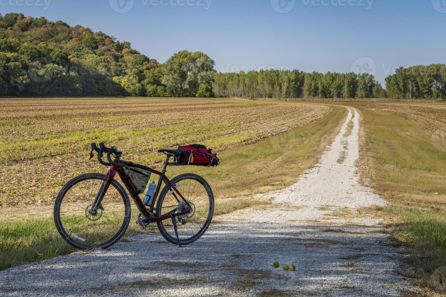 gravel touring bike on Steamboat Trace Trail converted from old railroad running across farmland and corn field near Peru, Nebraska photo