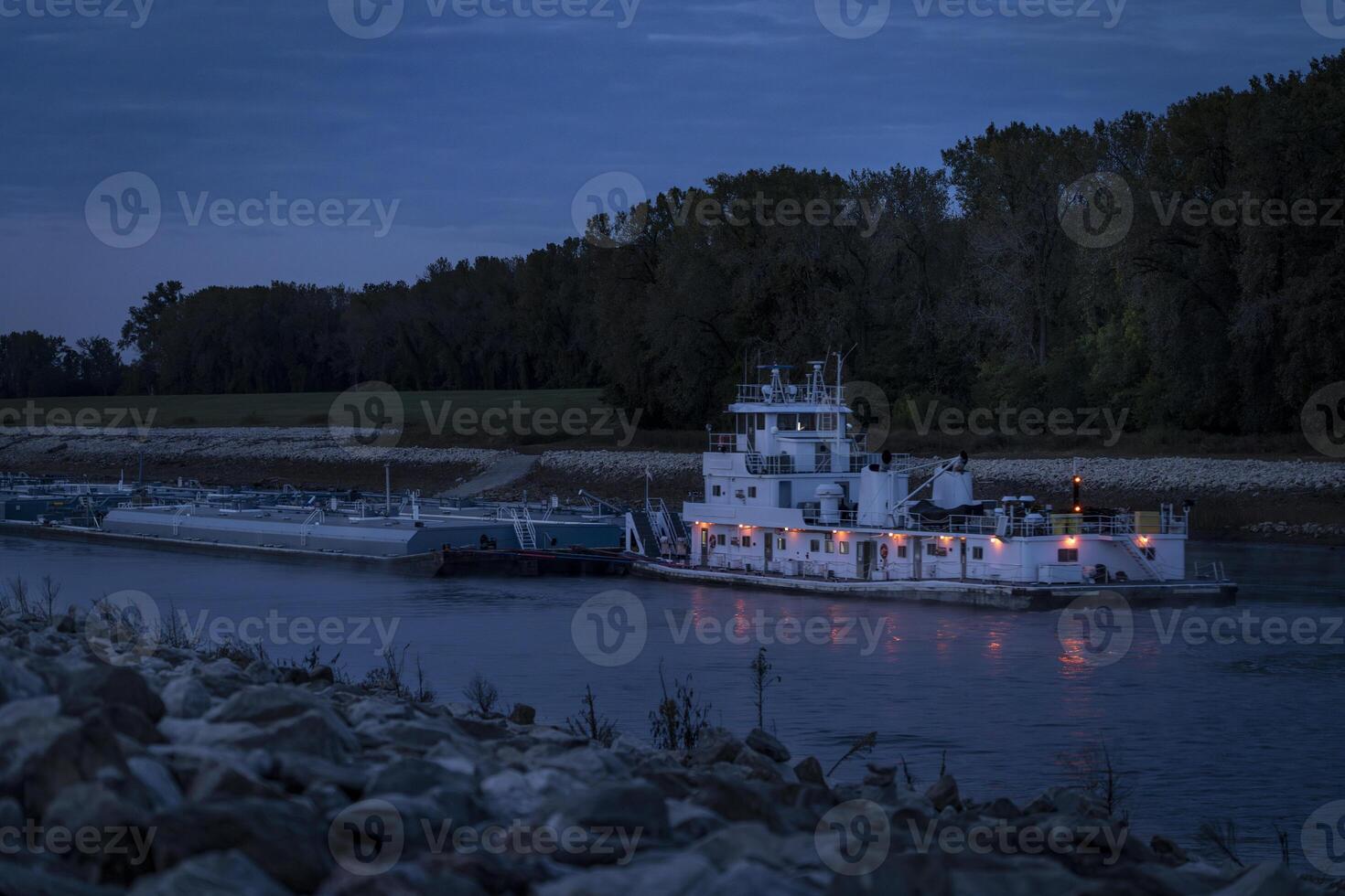 towboat with barges on Chain of Rock Bypass Canal of Mississippi River above St Louis, night scenery at dawn photo