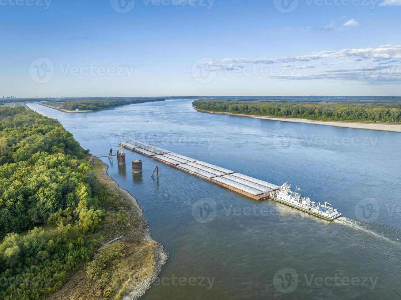 towboat with barges on the Mississippi River is entering Chain of Rocks Bypass Canal above St Louis photo