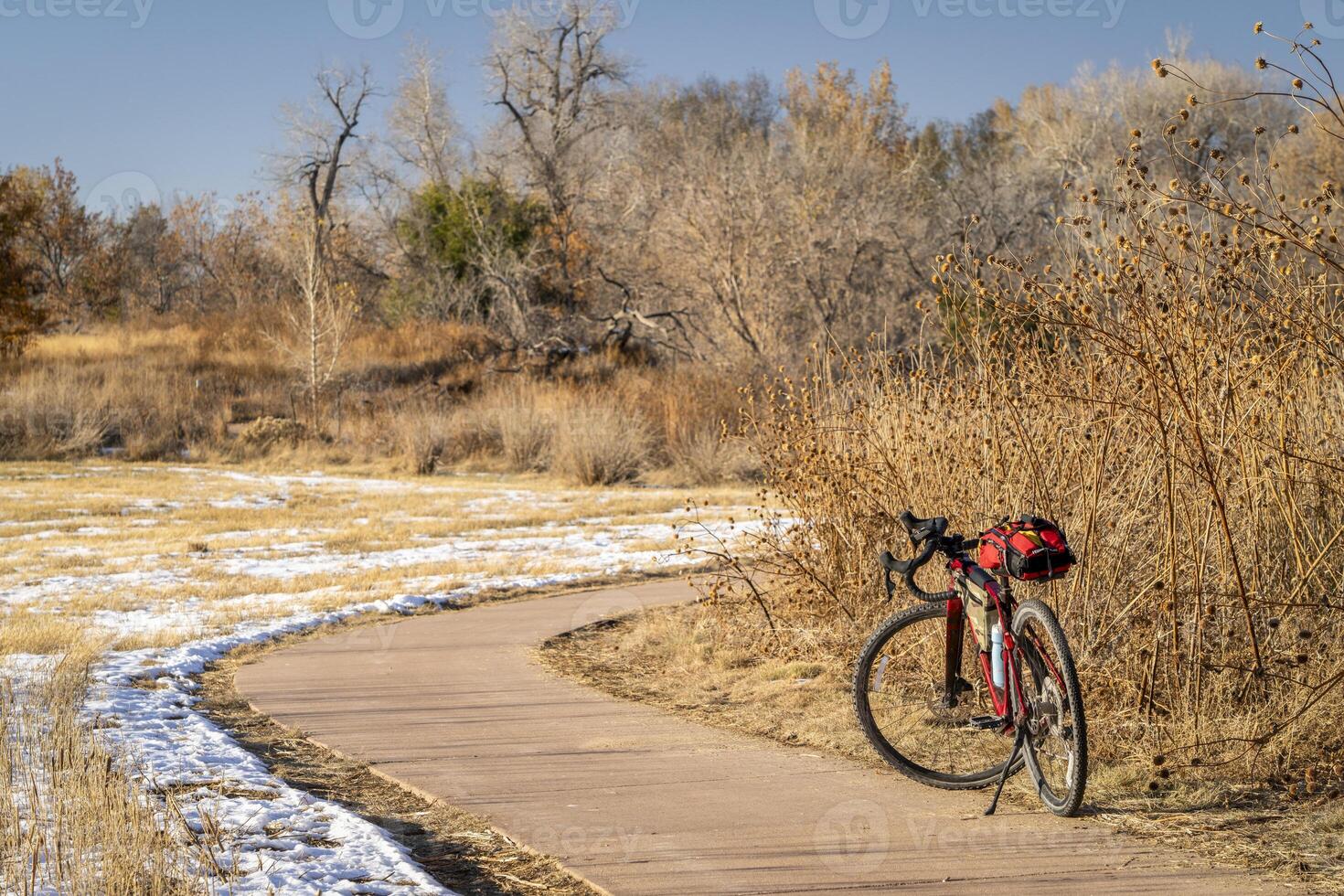 touring gravel bike at on a biking trail in Fort Collins, Colorado in fall scenery with some snow and dried sunflowers photo