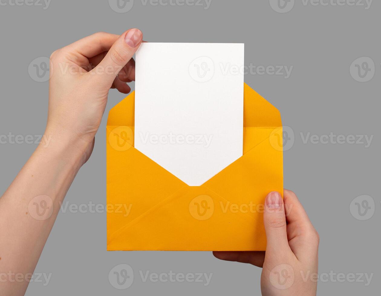 Holding open envelope with white blank card inside, vertical postcard mock up photo