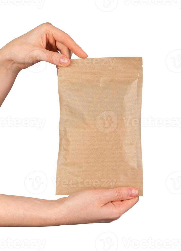 Hand holding zip-lock kraft paper bag. Ziplock pouch, craft eco package, soft pack photo
