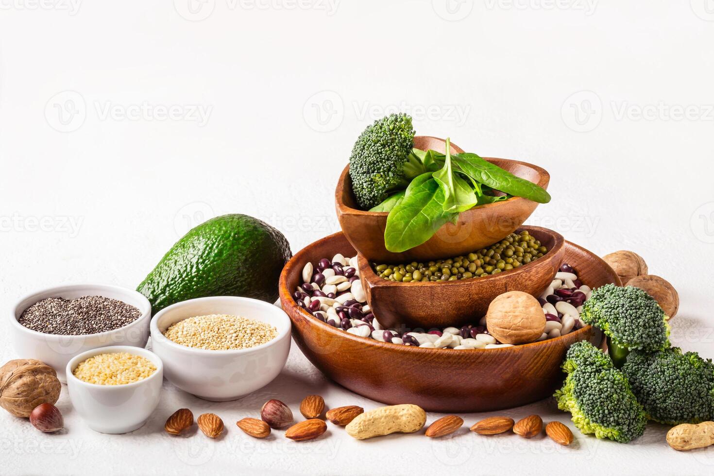 Diverse Sources of vegetable protein. Nuts, beans and broccoli on white background photo