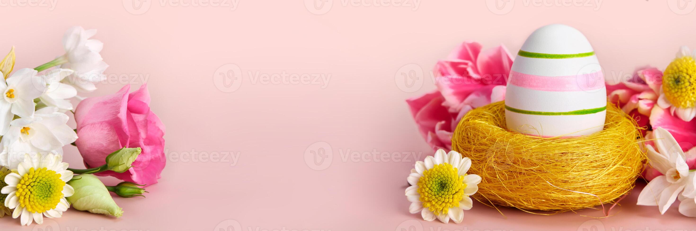 Easter creative composition. Spring flowers, Easter egg and butterflies on pink banner. Easter card photo