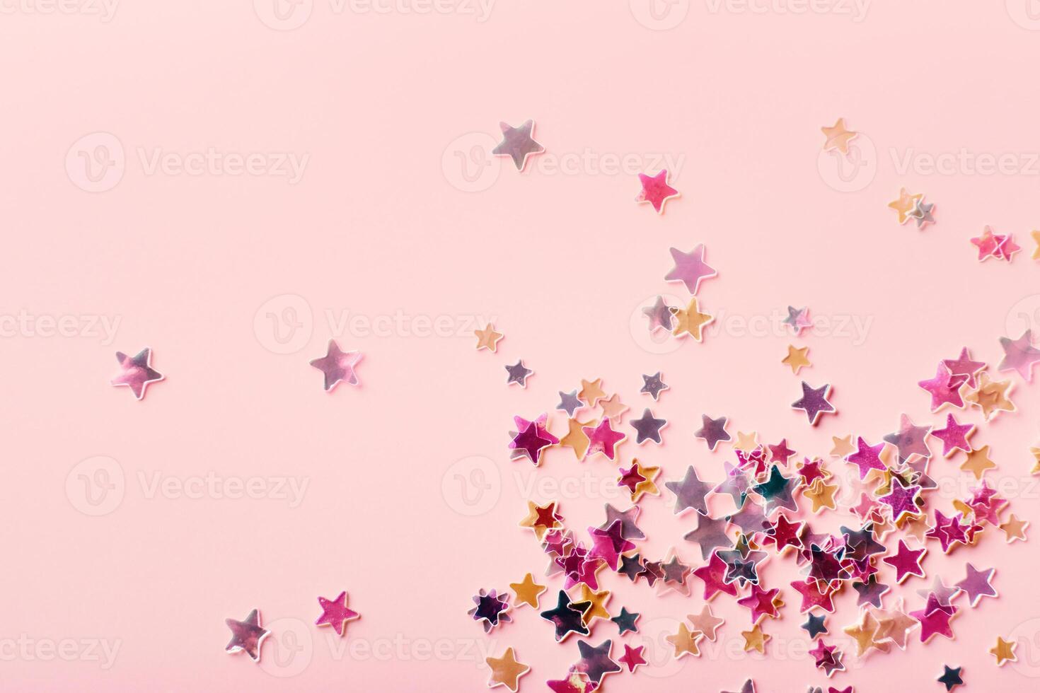 Pink and yellow pastel Stars Glitter Confetti on pink background. Festive backdrop photo