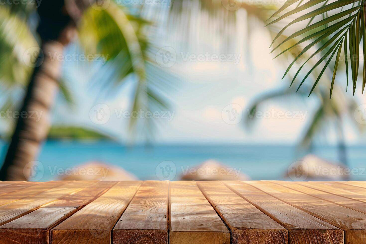 Top of wooden table with blurred bokeh light and palm leaf at tropical beach background. Free space photo