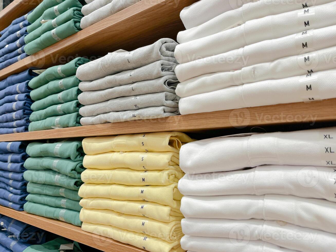 Folded shirts on a shelf in a store. photo