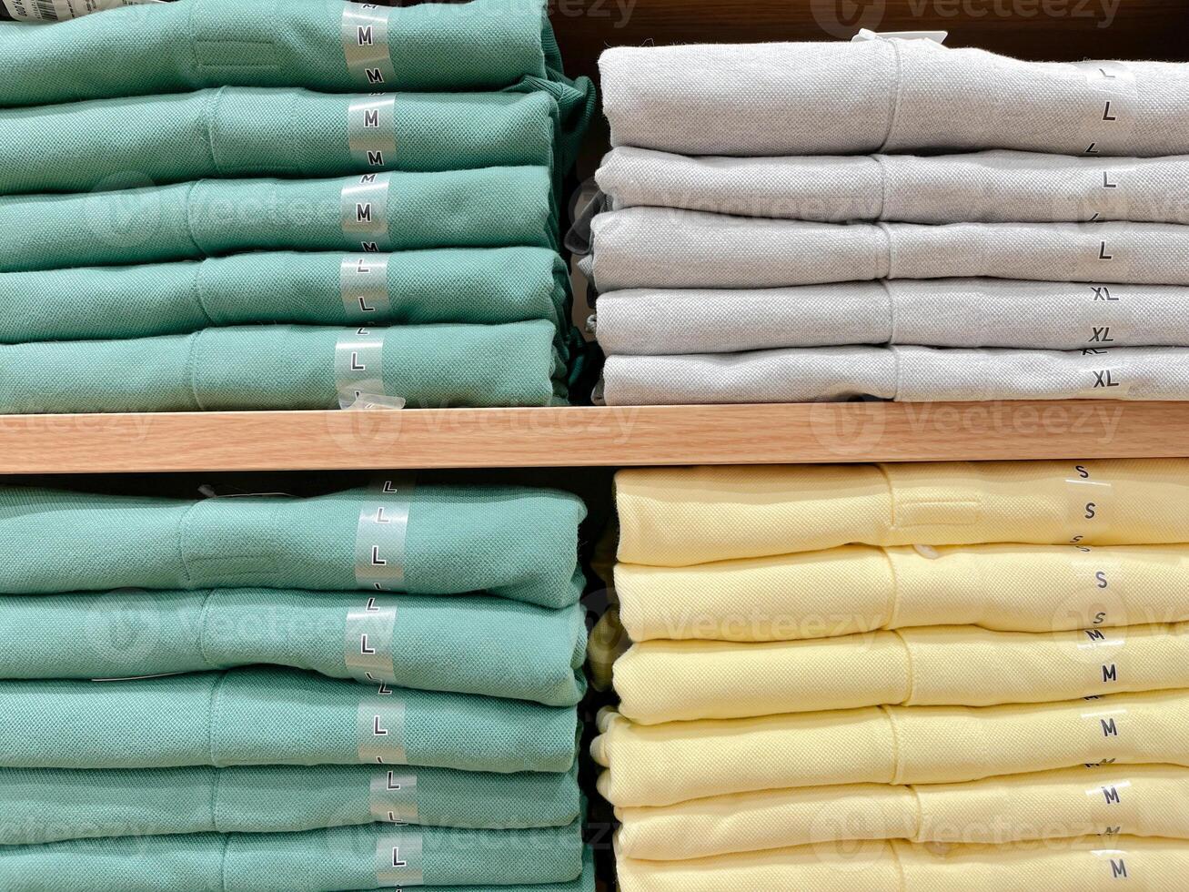 Folded shirts on a shelf in a store. photo