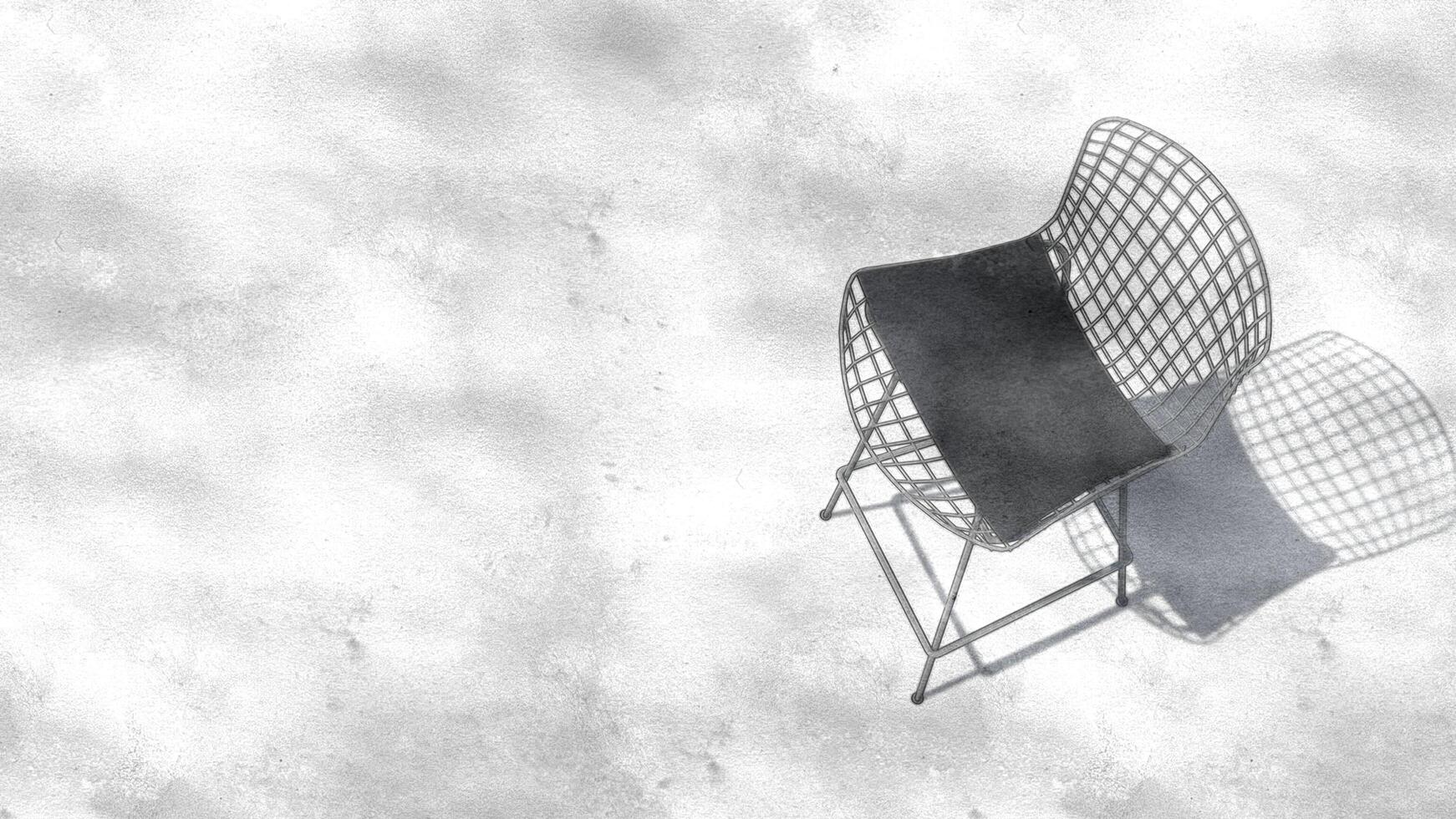 A white chair with a black cushion sits on a white wall photo