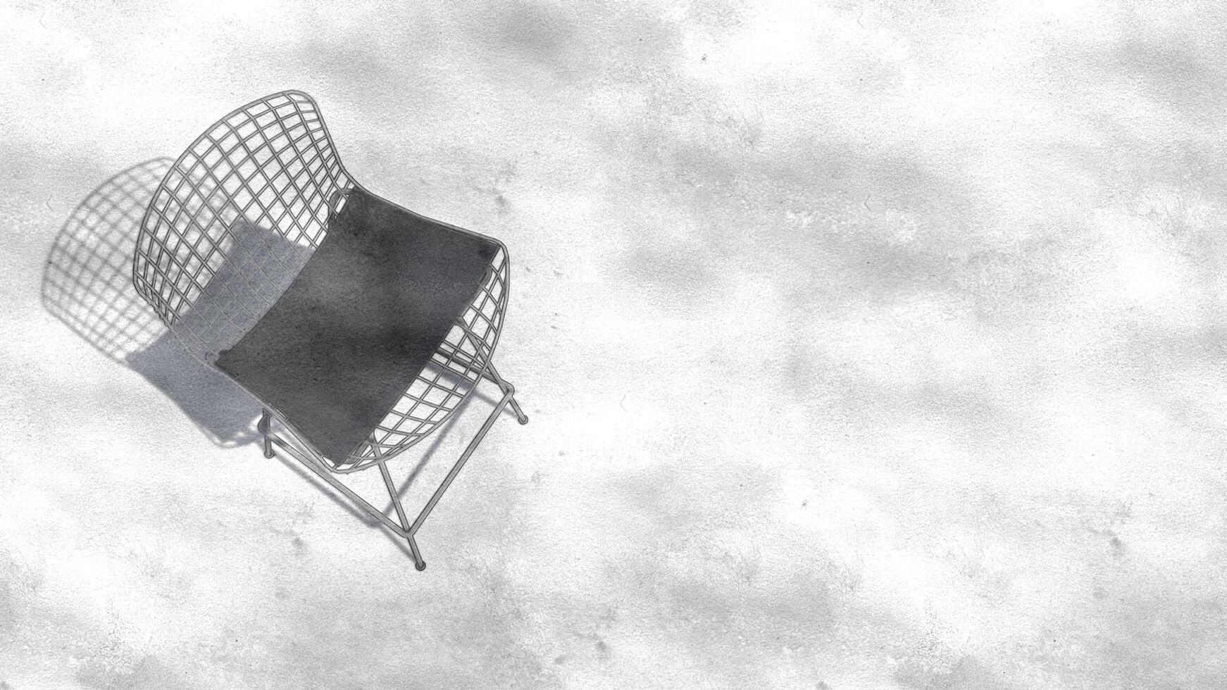 A white chair with a black cushion sits on a white wall photo