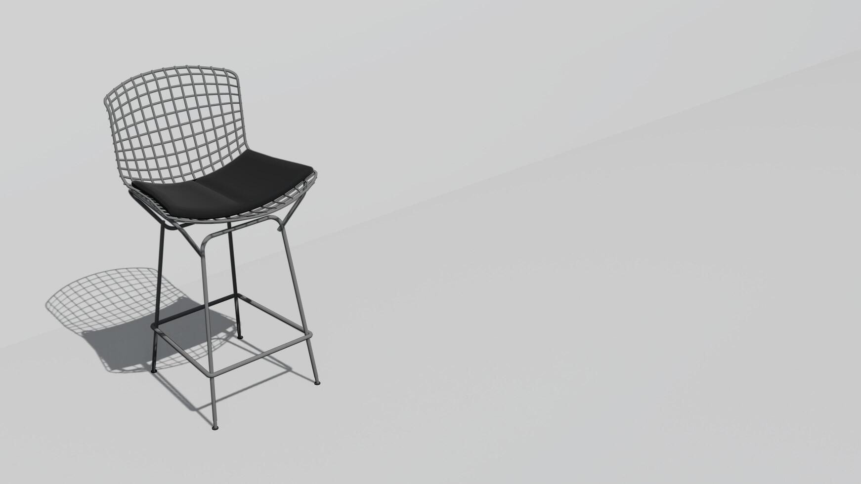 A white chair with a black cushion sits on a white wall photo