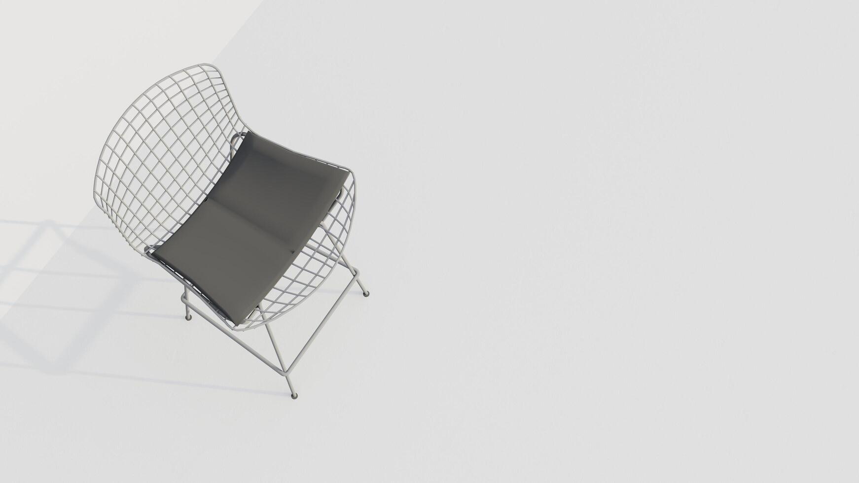 A white chair with a black cushion sits on a white wall photo