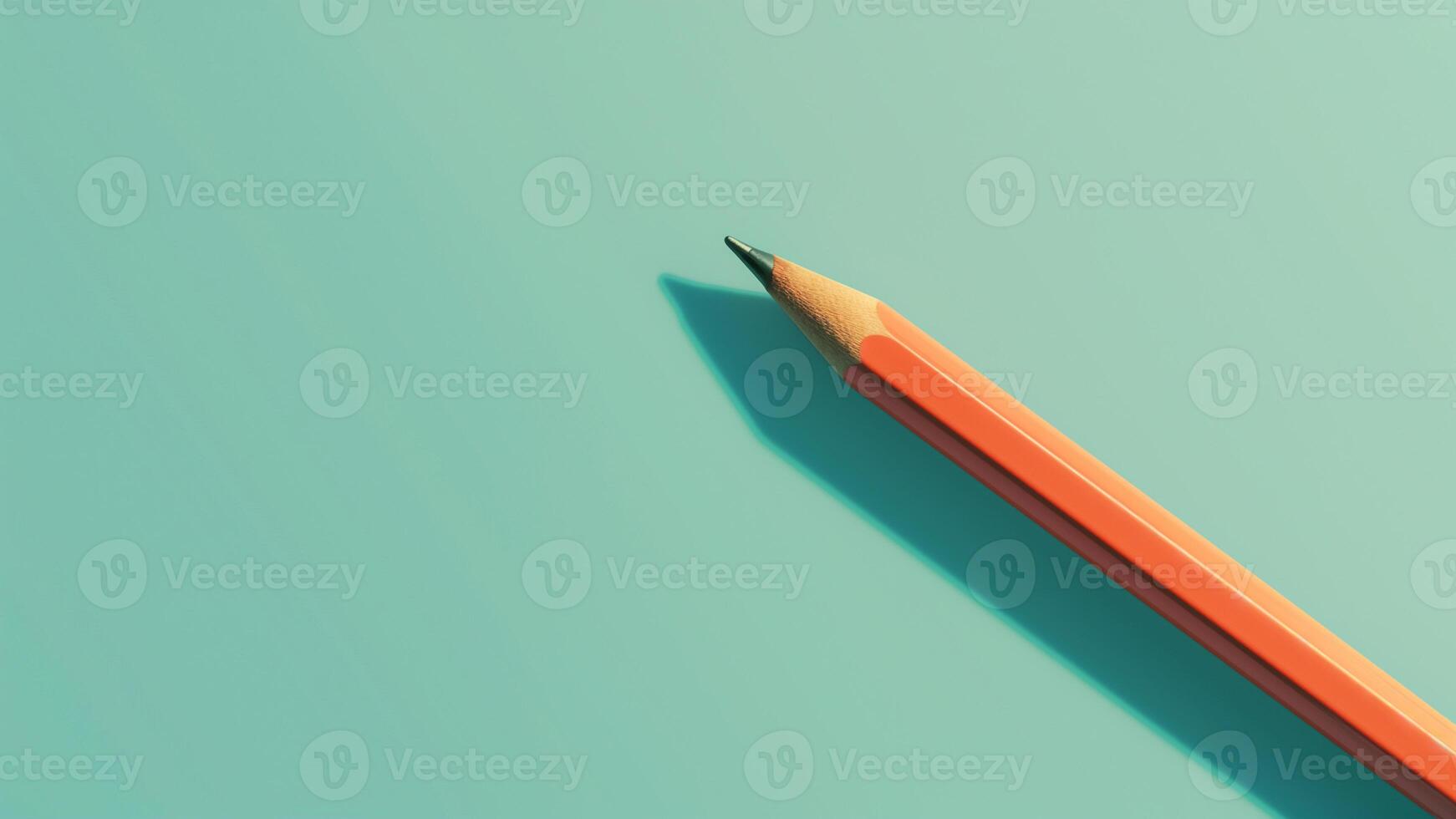 a pencil is sitting on top of a green surface photo