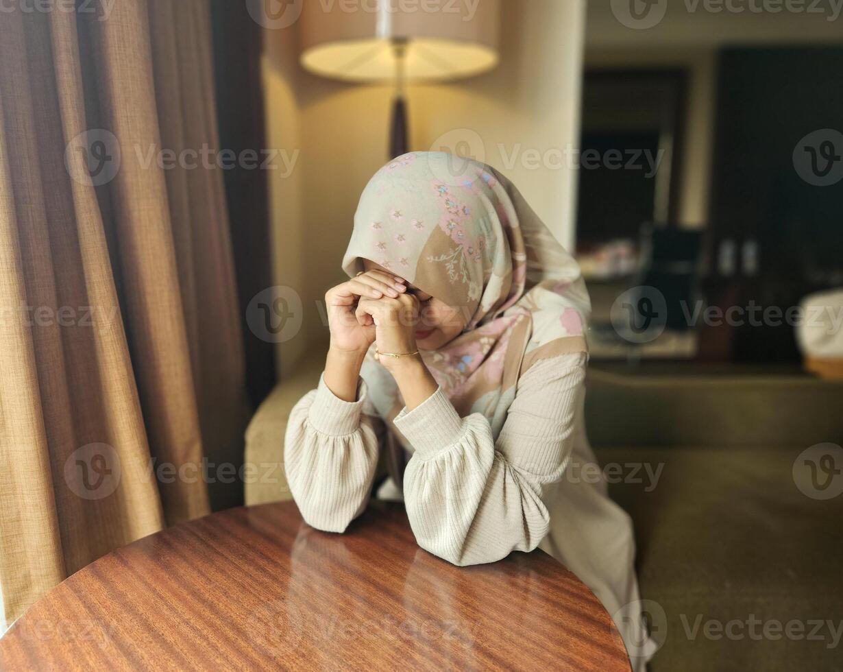 Asian Muslim woman wearing hijab having bad mood, upset tired bored expression, with blur background photo