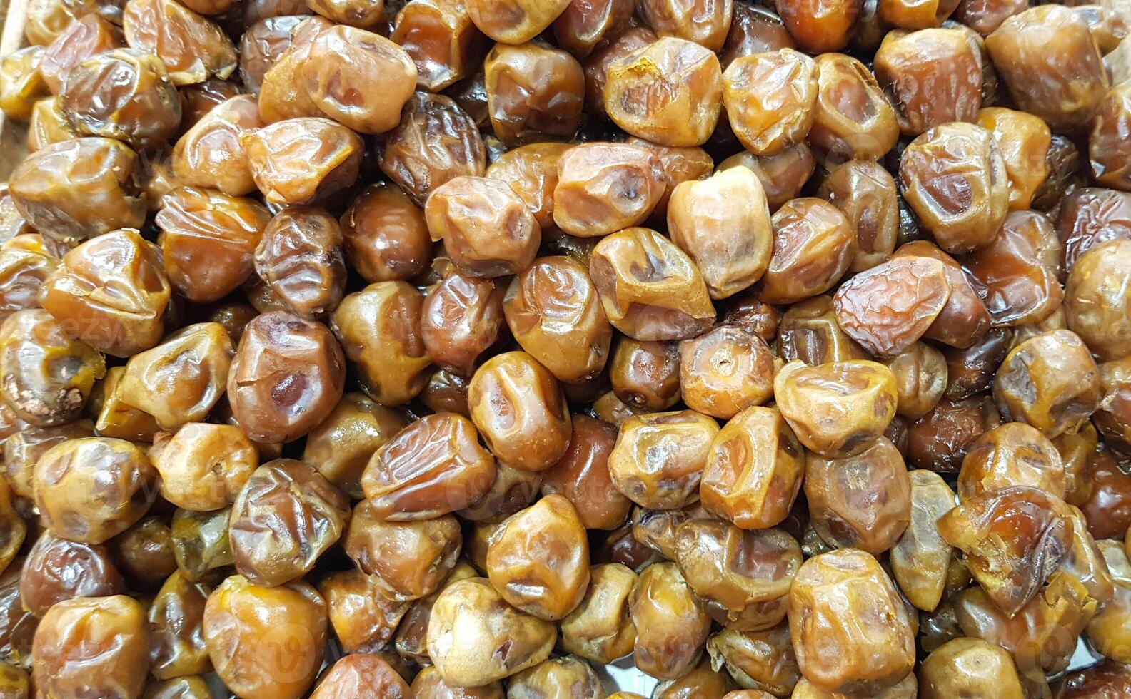 Full Frame Top View of a Stack of Mouthwatering Honey Dried Dates, Dates Arranged on a Table, Dates Background photo