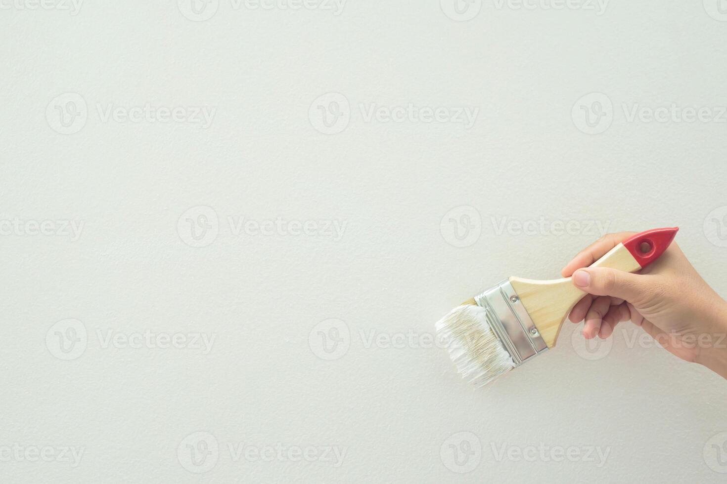 Roller Brush Painting, Worker painting on surface wall Painting apartment, renovating with white color paint. Leave empty copy space white to write descriptive text beside. photo