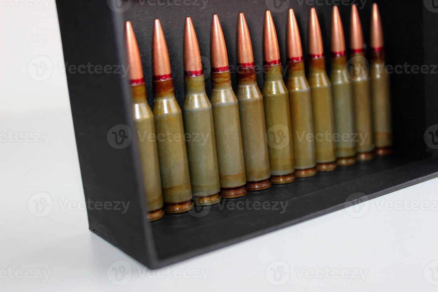 Line Of Rifle Bullets In Cardboard Box Angle View Stock Photo