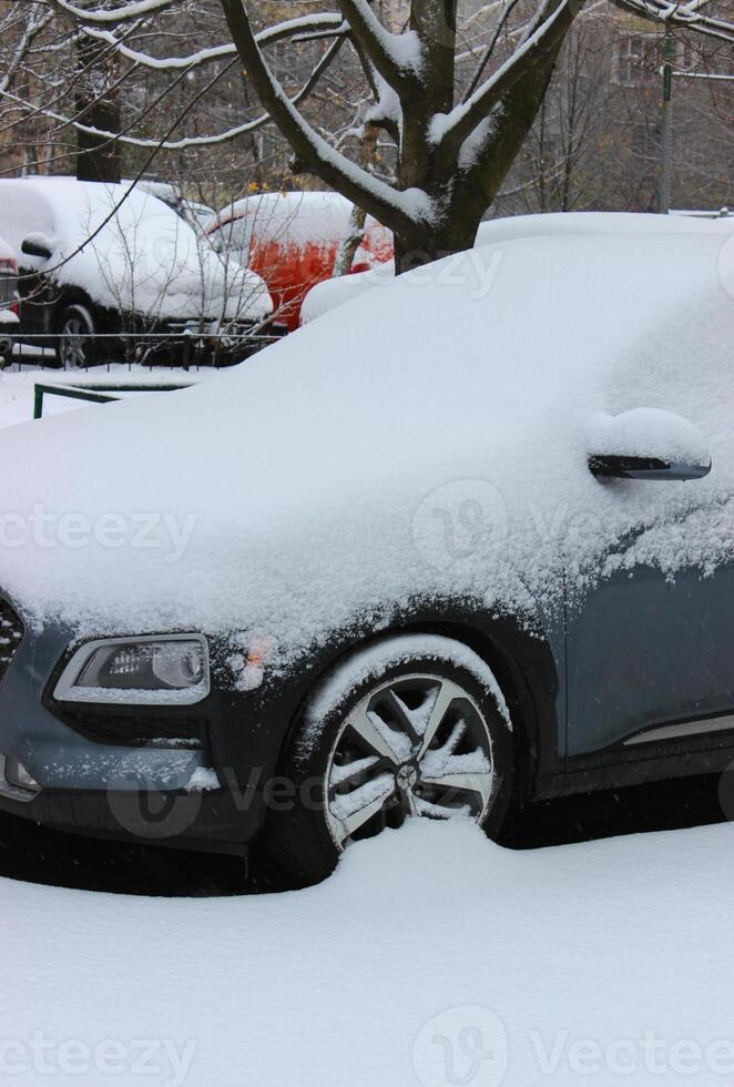 Cars Covered With Snow At Outdoor City Parking photo