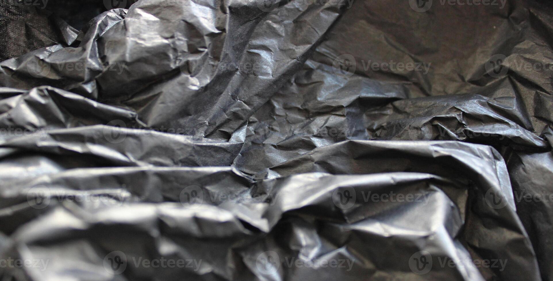 Black Wrapped Plastic After Use Close Up View. Plastic Texture Stock Photo