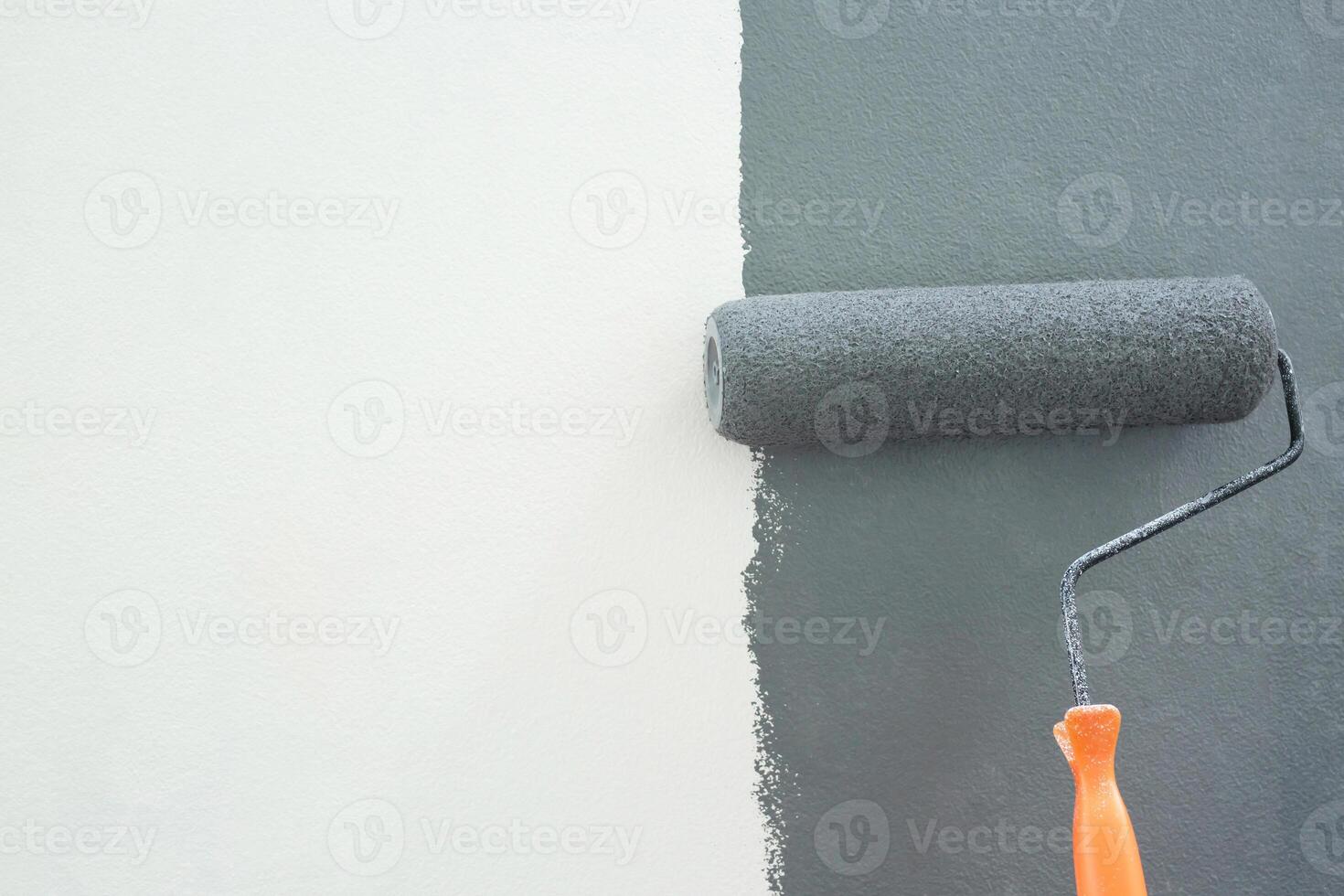 Roller Brush Painting, Worker painting on surface wall Painting apartment, renovating with grey color paint. Leave empty copy space white to write descriptive text beside. photo