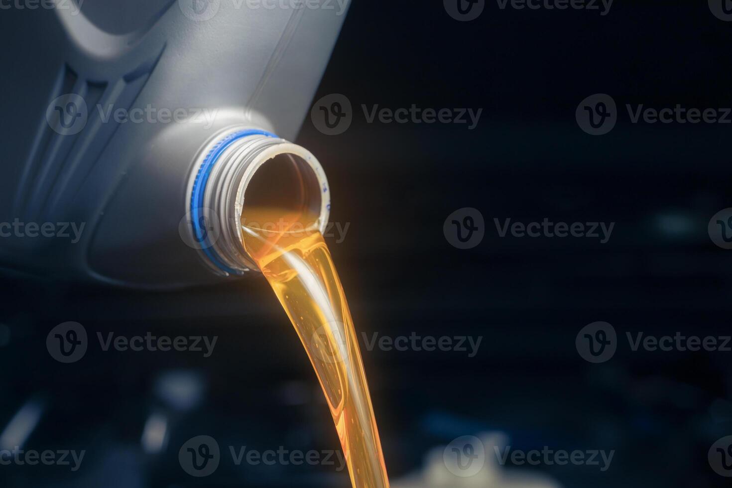 Pour engine oil from the lubricant bottle. Engine background, oil change shop engine service industry photo