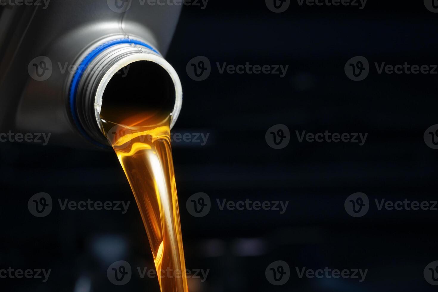 Pour engine oil from the lubricant bottle. Engine background, oil change shop engine service industry photo