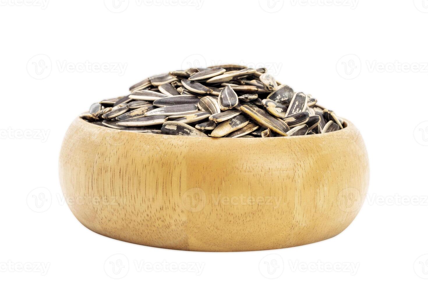 Sunflower seeds in a wooden bowl, healthy natural food Isolated on a white background - clipping path photo
