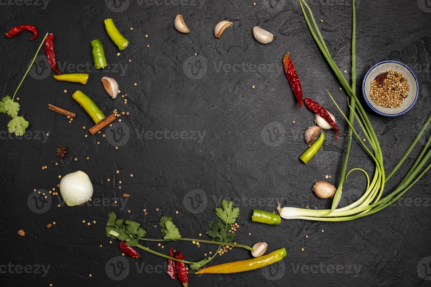 Condiments scattered on the black background photo