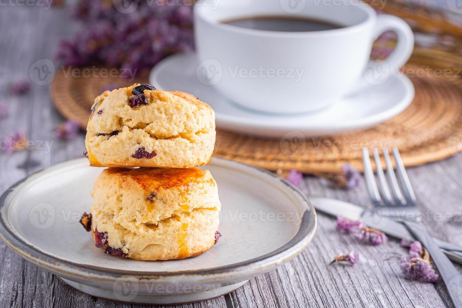 Traditional British scones with a white coffee cup cup and blurred background photo