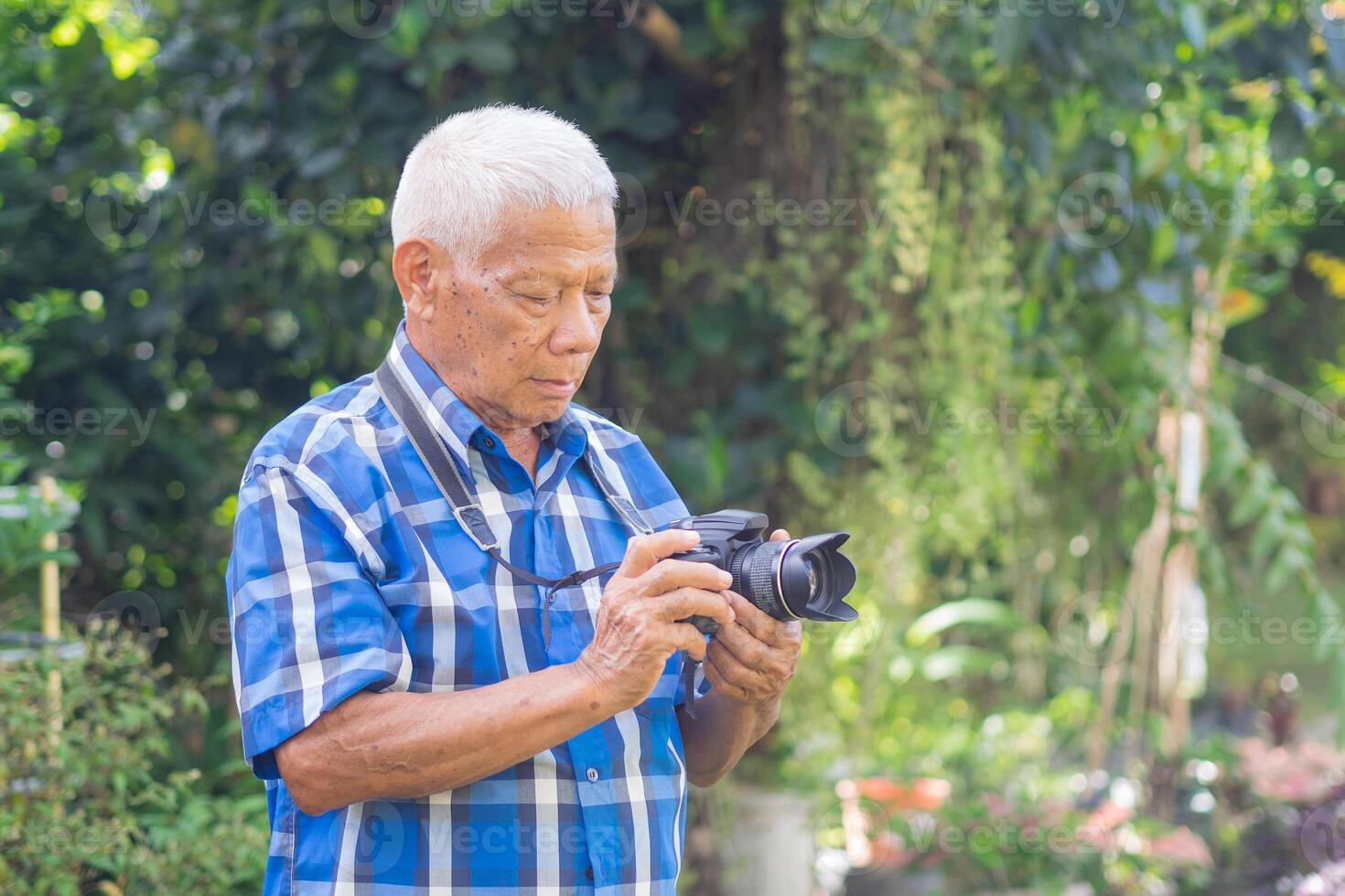 Senior man using a camera to take photo