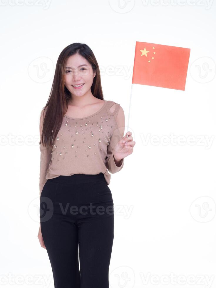 Young woman holding China flag, smiling and looking at the camera with a white background while standing in the studio. Space for Text photo