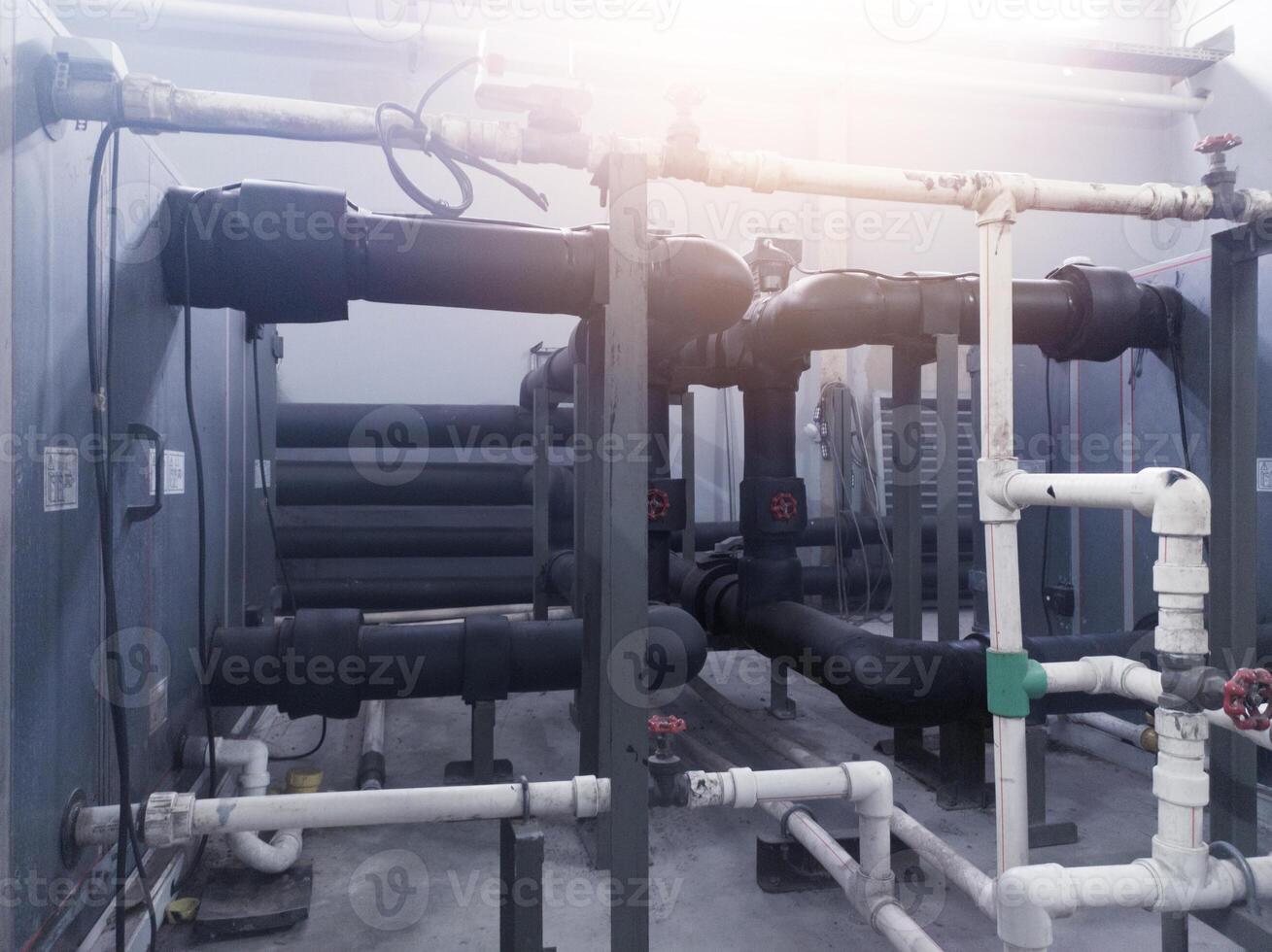 Installation water circulation pipes on the Air Handling Unit, water chiller and boiler system. photo
