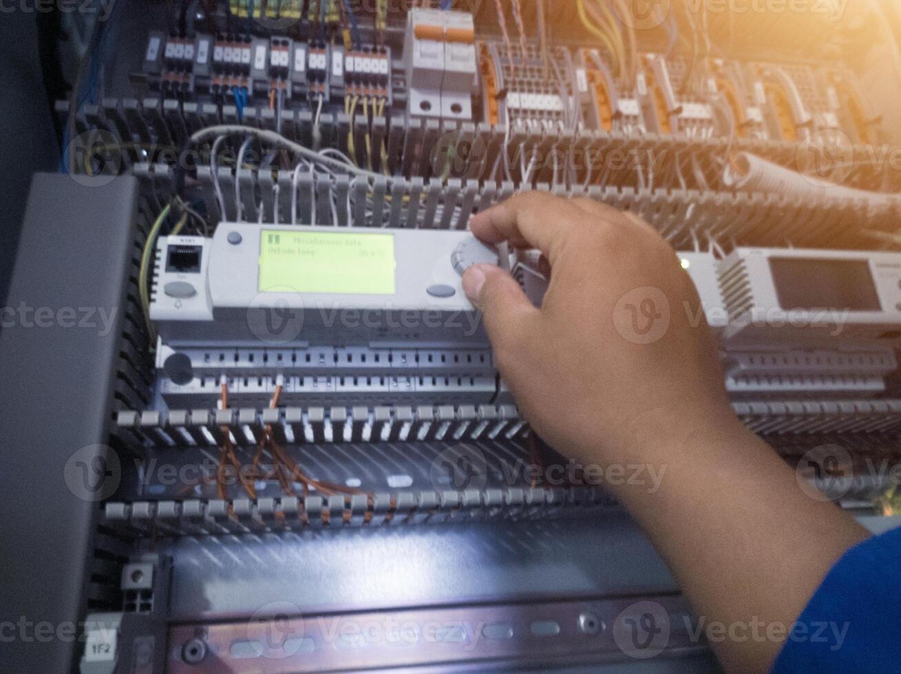 The Technician setting the parameter of the AHU control monitoring system. photo