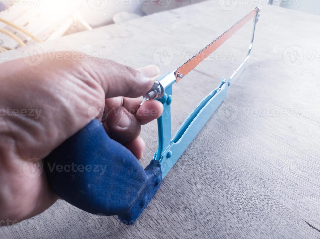 The hand adjusting the screw adjuster Pipe saw for plumbing work tools. photo