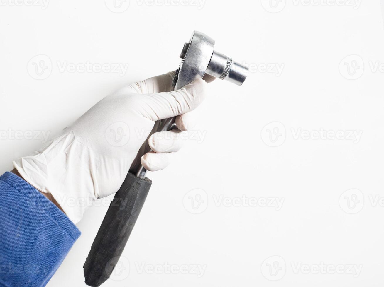 Man's hand with gloves holds a Ratchet Wrench isolated on white background, Mechanical tools wrench concept. photo