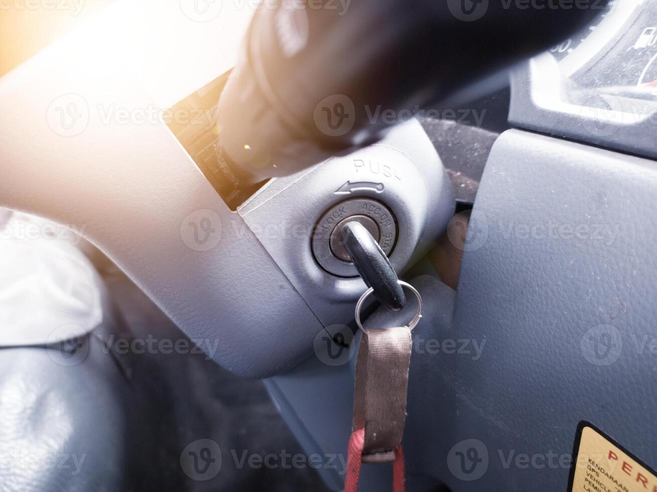 Key inserted into the lock of ignition switch of the vehicle truck. photo
