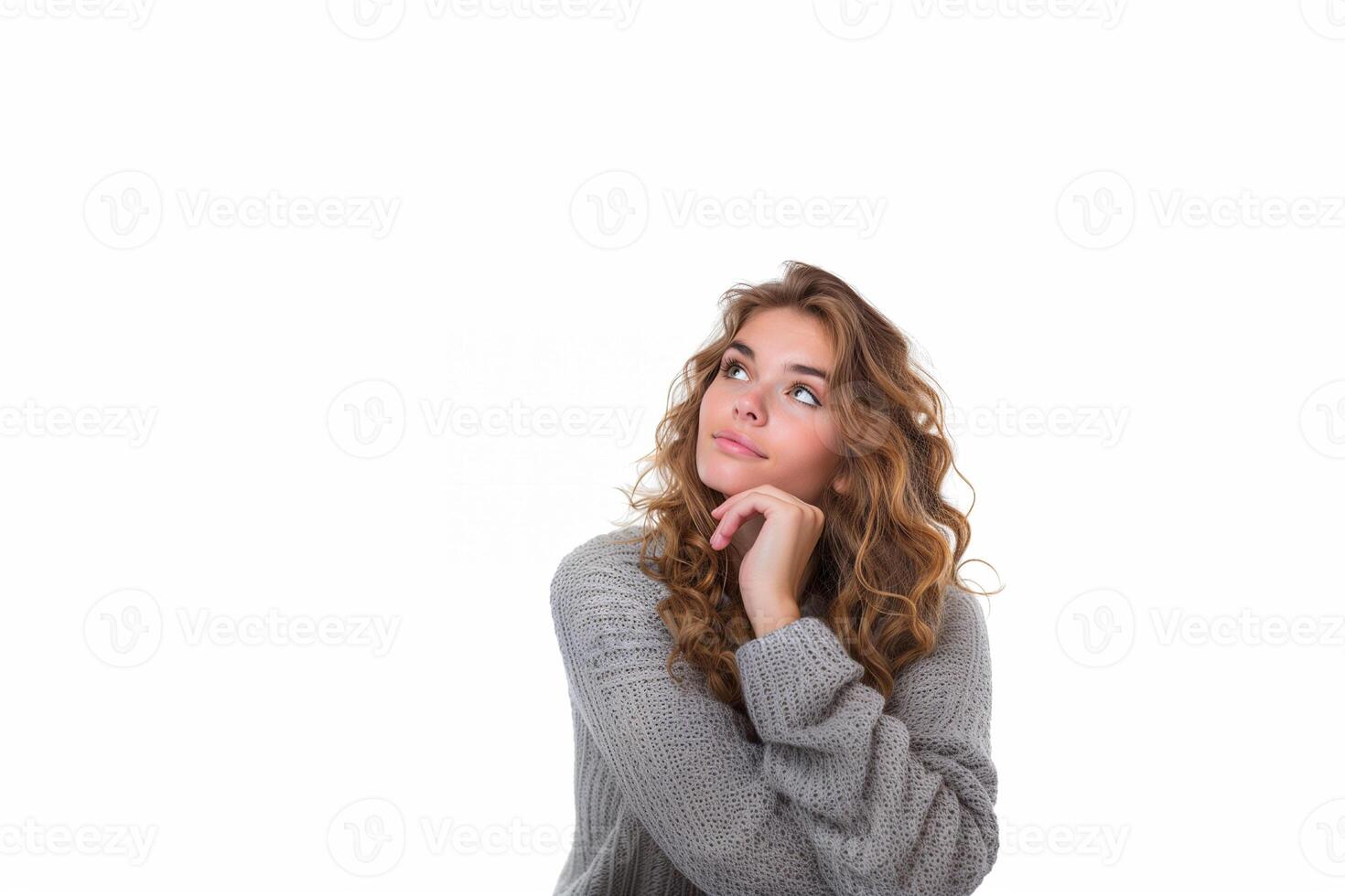 Beautiful woman thinking about question, pensive expression, wearing gray sweater with hand on chin, isolated on white photo