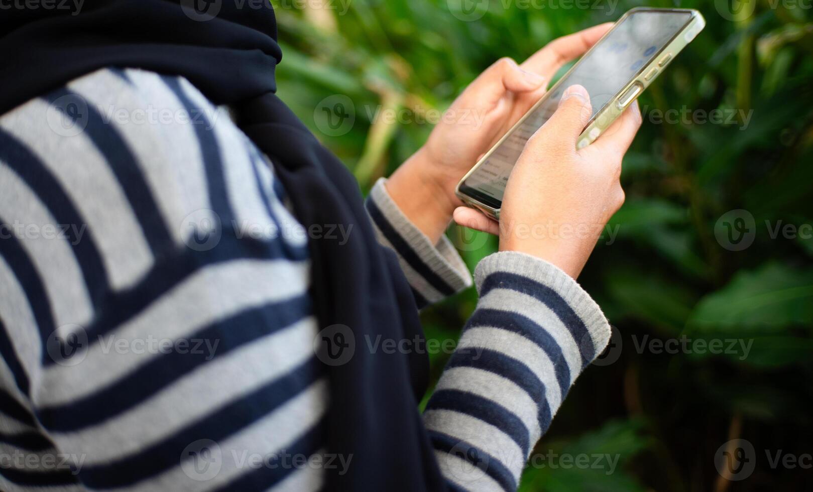 a woman holding a smart phone photo