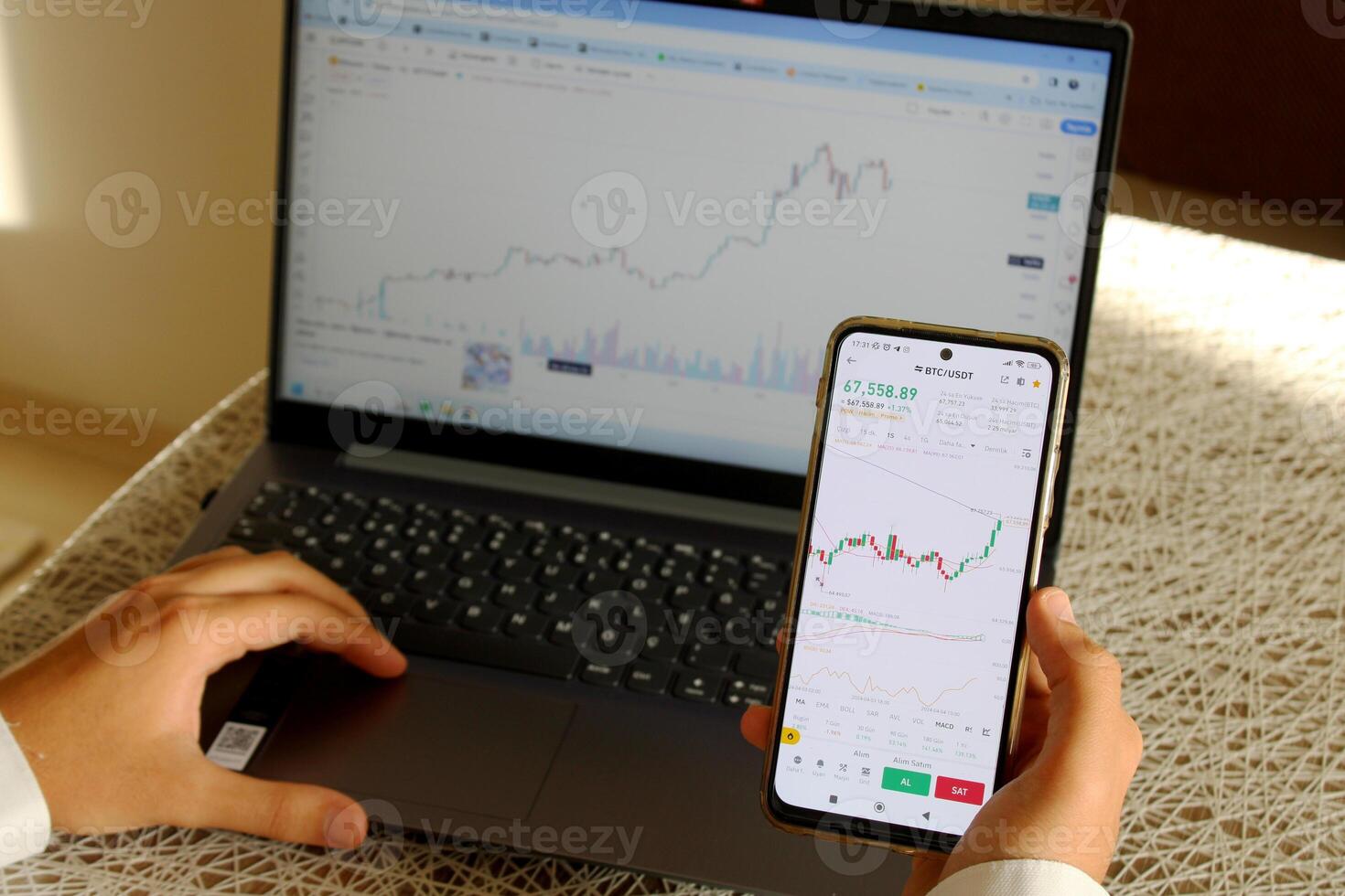 An investor who buys coins with a credit card. bitcoin chart on computer in background photo