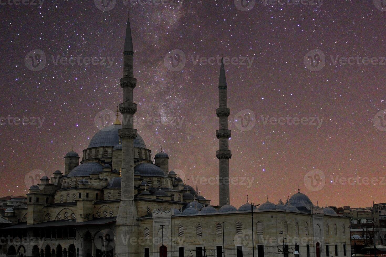 a city at night with the lights on the eminonu mosque .Happy the 27th day of Ramadan or laylat al-qadr. Istanbul, Turkey photo